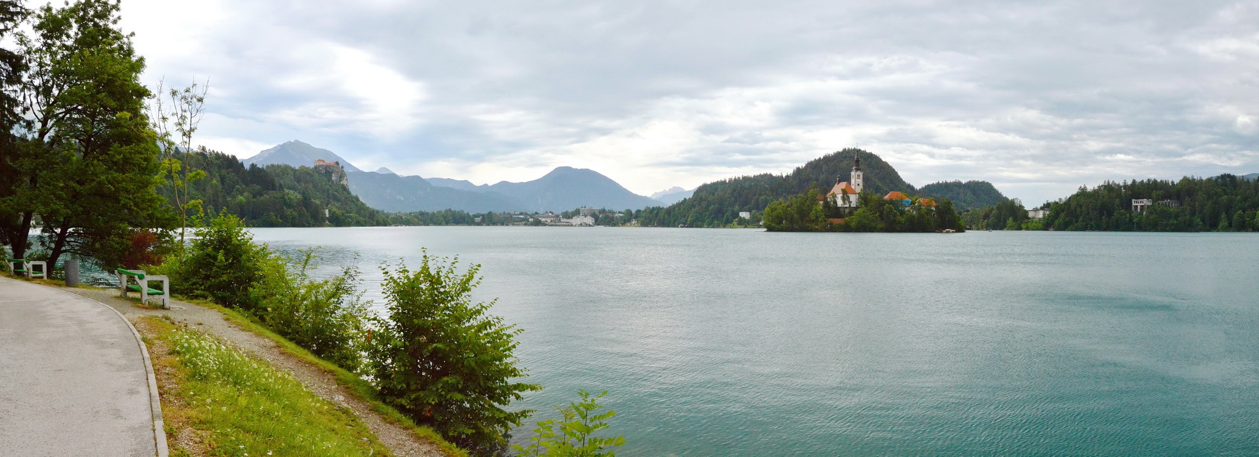 View of Lake Bled and Bled Castle in distance, looking from the Veslaška Promenade