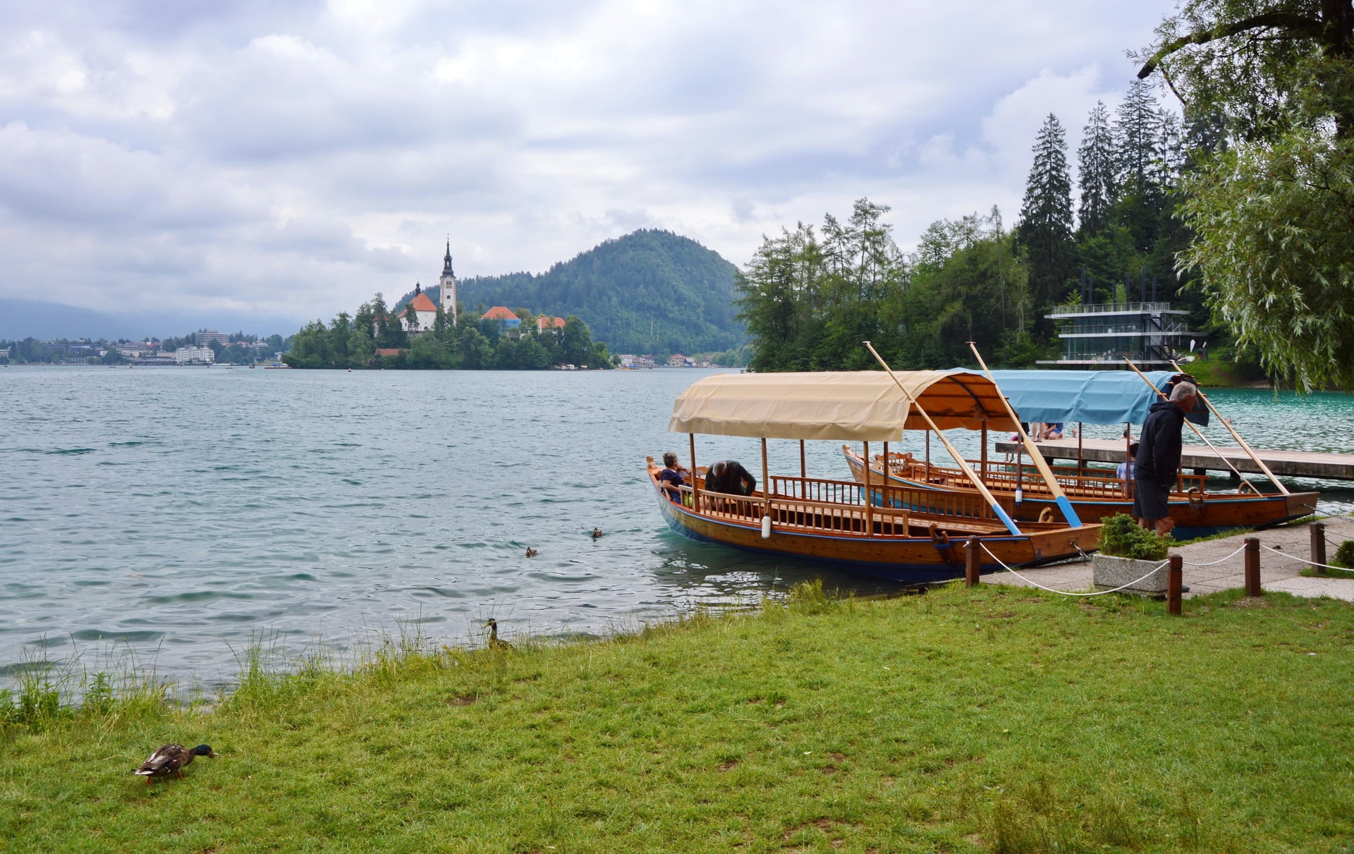 Traditional pletna boats take visitors to the island in the middle of Lake Bled