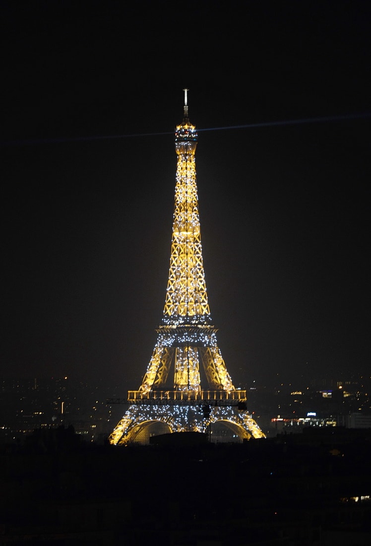 The Eiffel Tower flashes every hour of night, looking from Arc de Triomphe